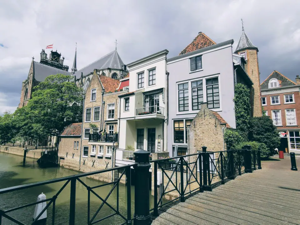 Historic buildings and a footbridge beside the water in Dordrecht